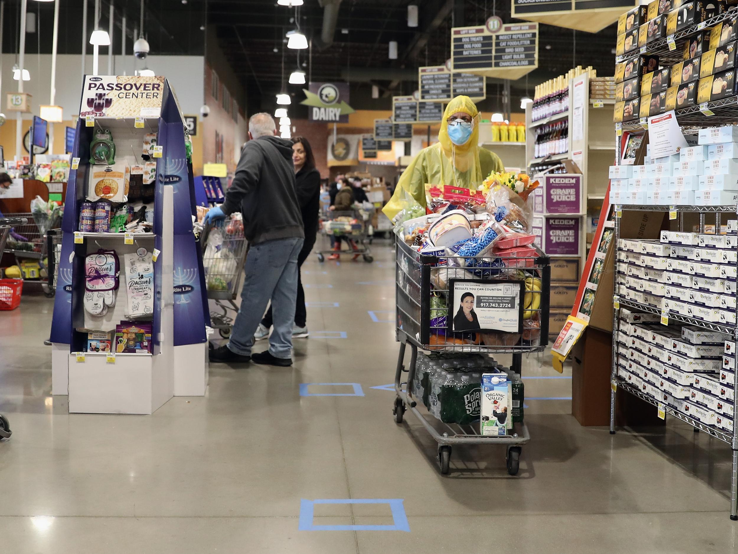 A shopper wearing PPE makes her way through the ShopRite supermarket