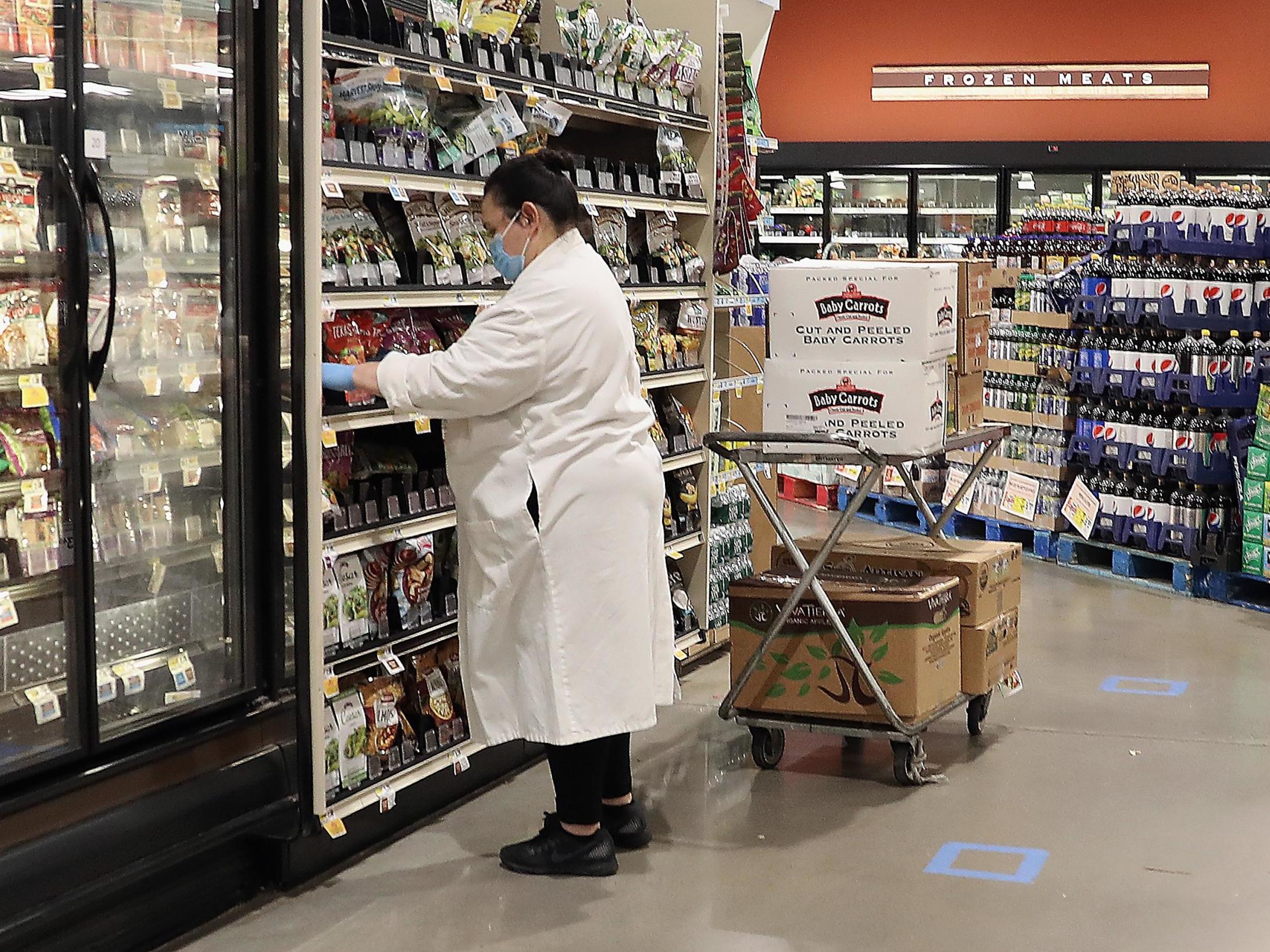 A worker at the ShopRite supermarket restocks shelves