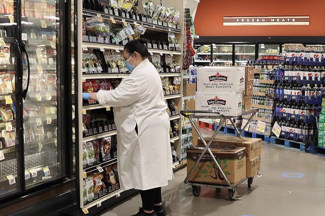 A worker at the ShopRite supermarket restocks shelves