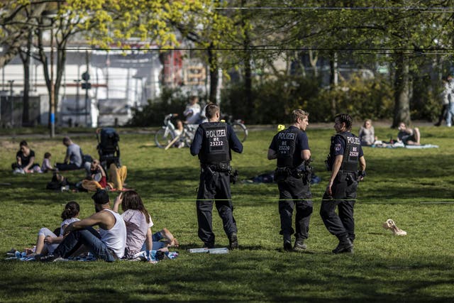 Police control a Kreuzberg park yesterday as the number of confirmed coronavirus cases in Germany surpasses 100,000