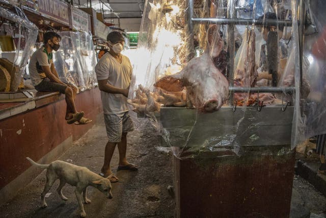 Stalls inside a wet market are seen covered in plastic to enforce social distancing in The Philippines