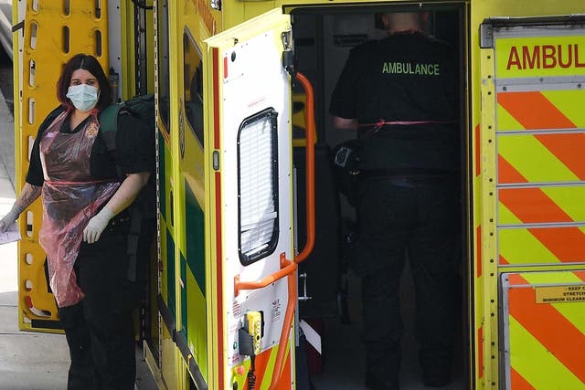 NHS ambulance staff arrive at a call out in London, Britain, 13 April, 2020