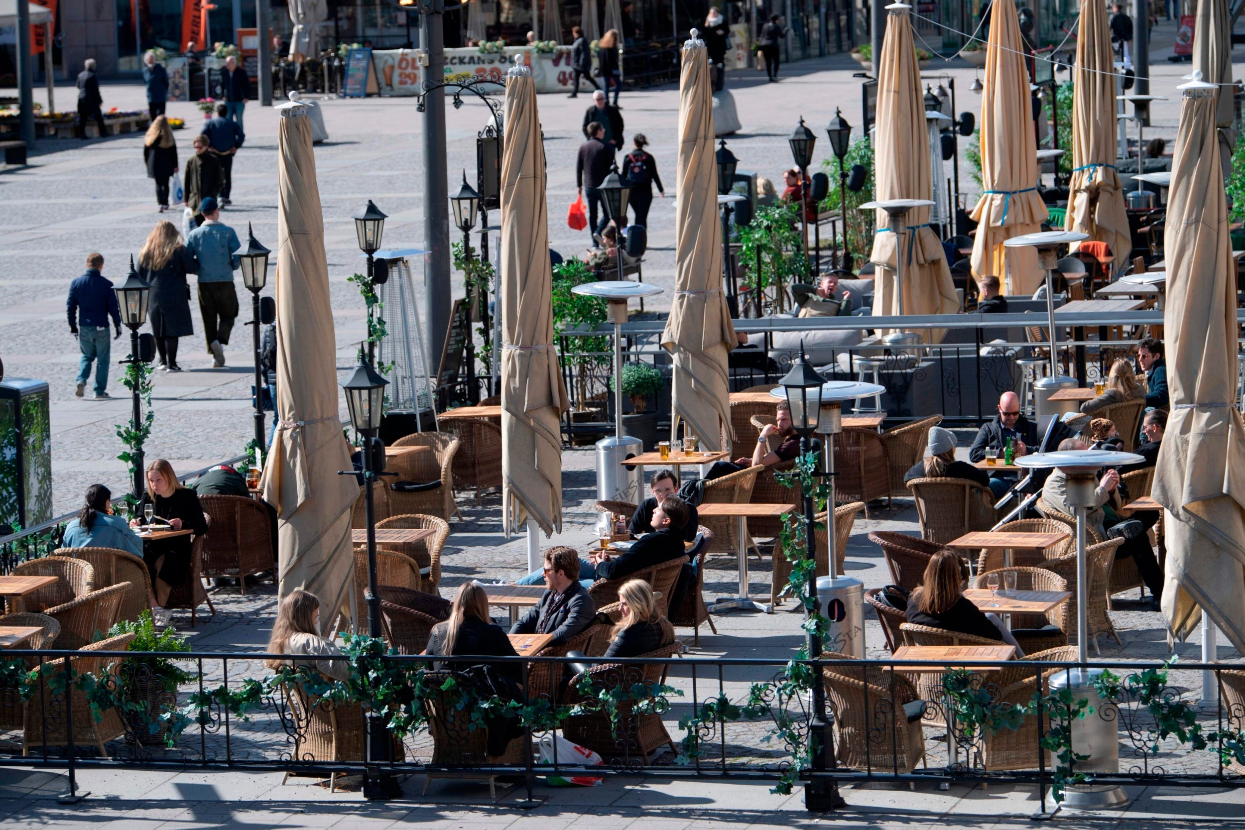 People sit at a cafe terrasse in central Stockholm