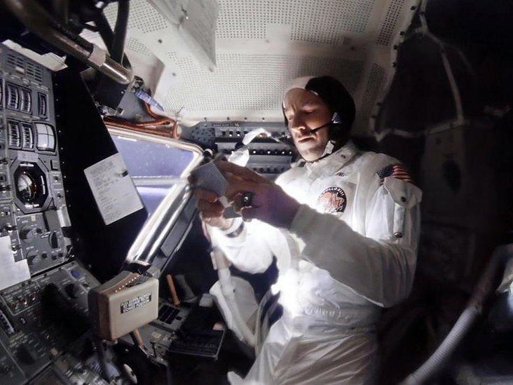 An enhanced image from the 1970 Apollo 13 mission shows Commander Jim Lovell selecting music on a tape player
