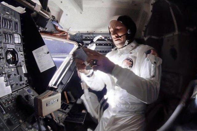 An enhanced image from the 1970 Apollo 13 mission shows Commander Jim Lovell selecting music on a tape player