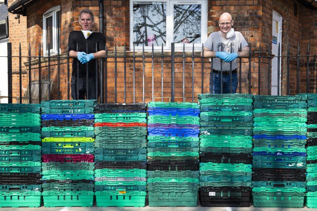 Service manager Laurence Foy (right) and Liam Hearte (left) from charity Build on Belief await a Felix food delivery outside the Acorn Hall in North Kensington