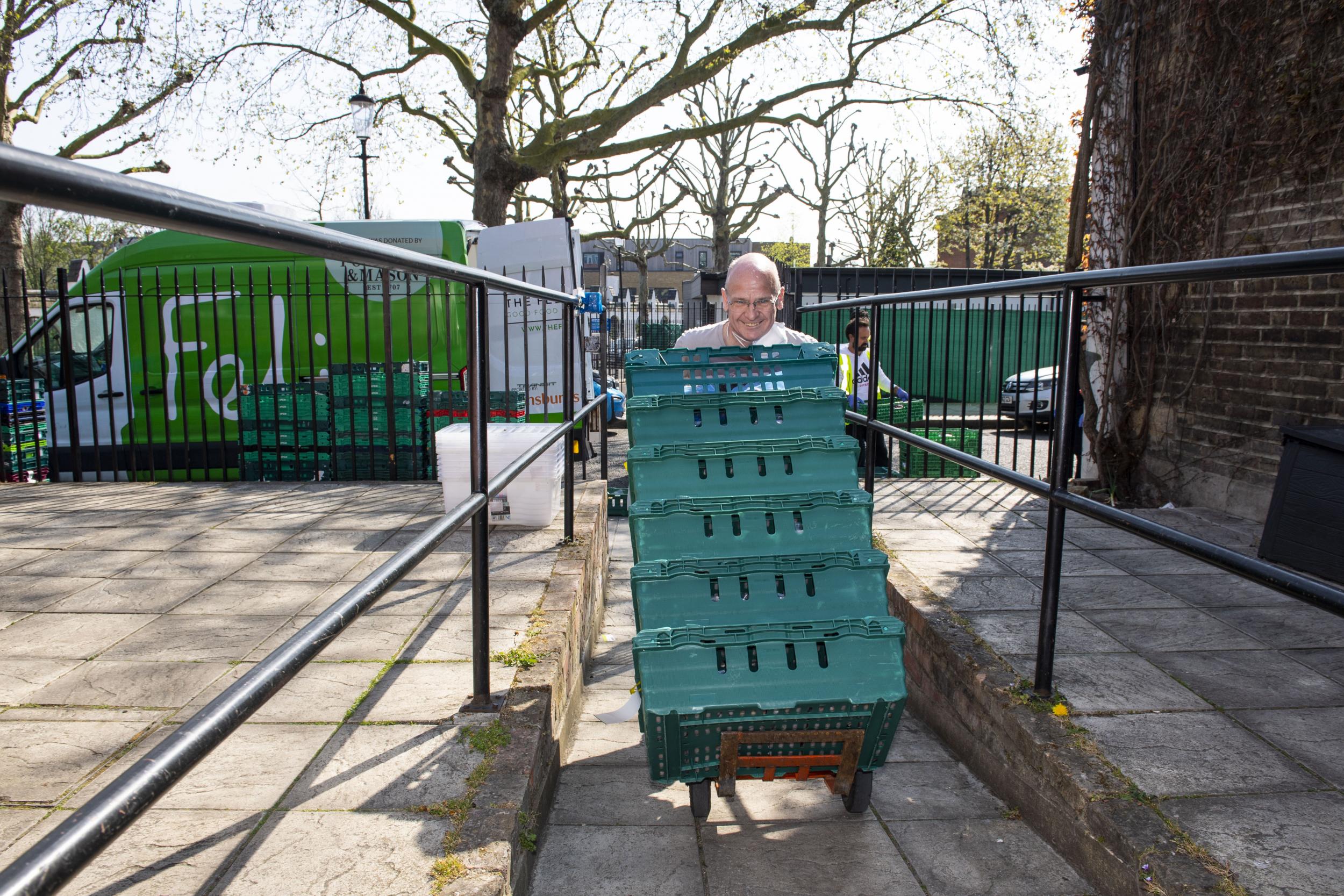 Foy, from charity Build on Belief, brings in donated food to the Acorn Hall in North Kensington