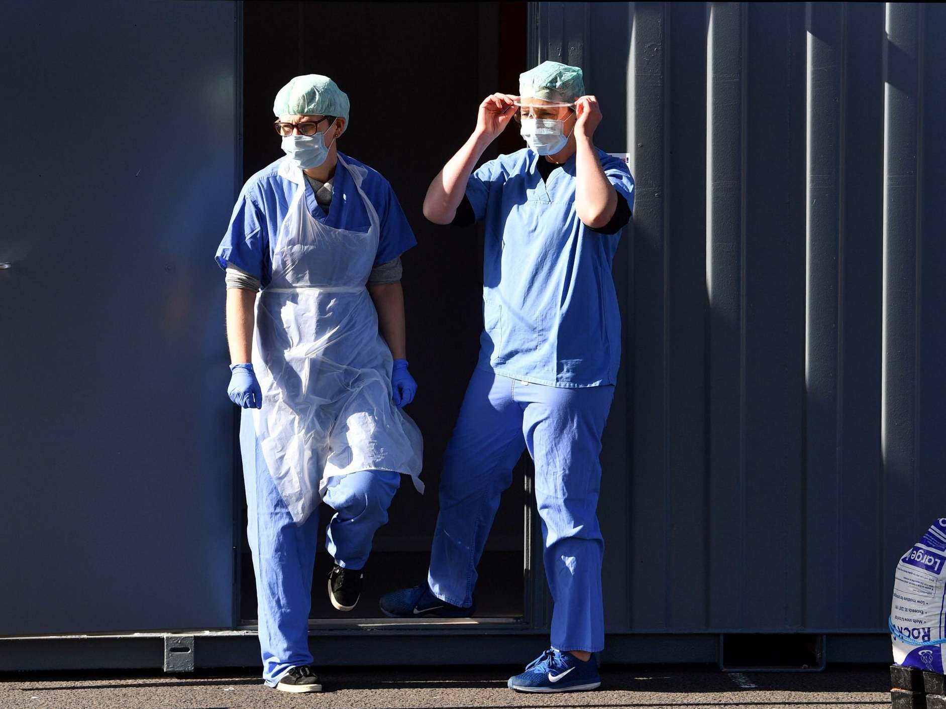 Medical staff in Wolverhampton wear PPE of gloves, eye protection, face masks and aprons, as they wait to test NHS workers at a drive-in facility