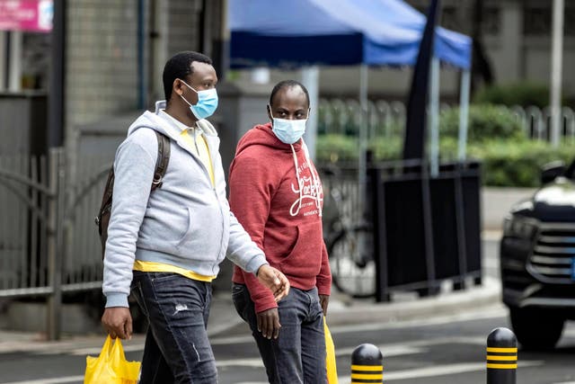 African people wearing masks walk on the street in Guangzhou