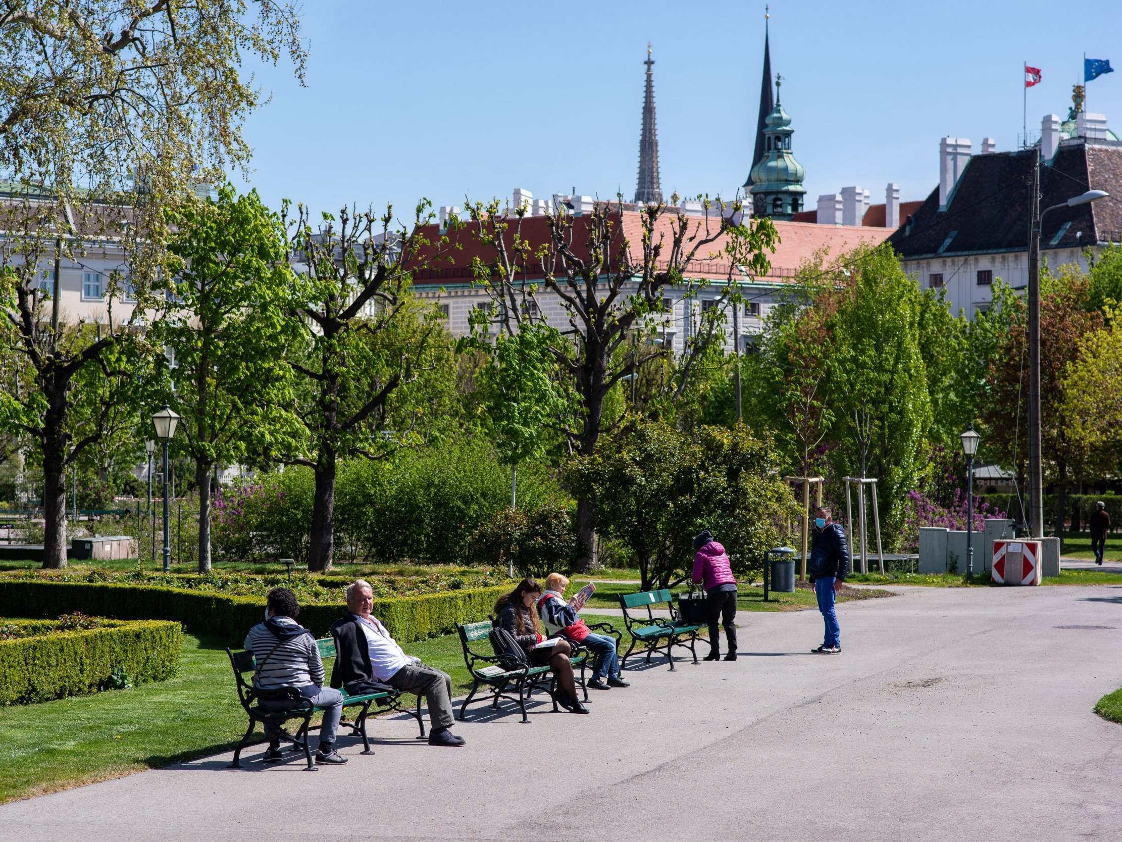 People enjoy the sun in Vienna’s reopened Volksgarten on Wednesday, following an easing of restrictions during the coronavirus crisis