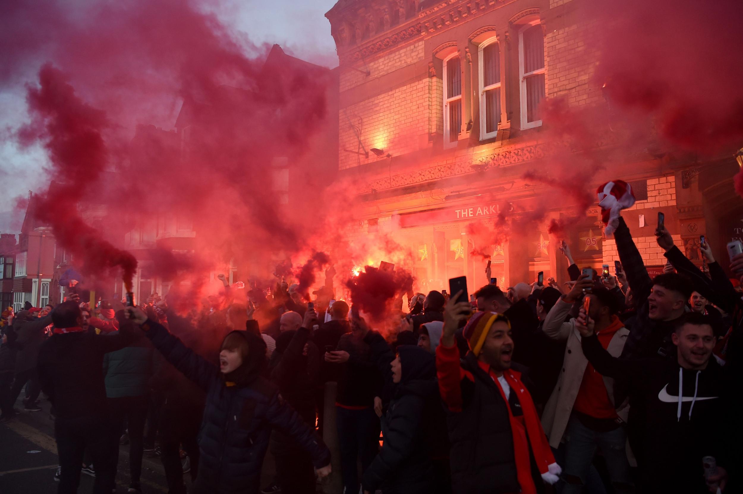 Liverpool fans light flares outside Anfield before the game