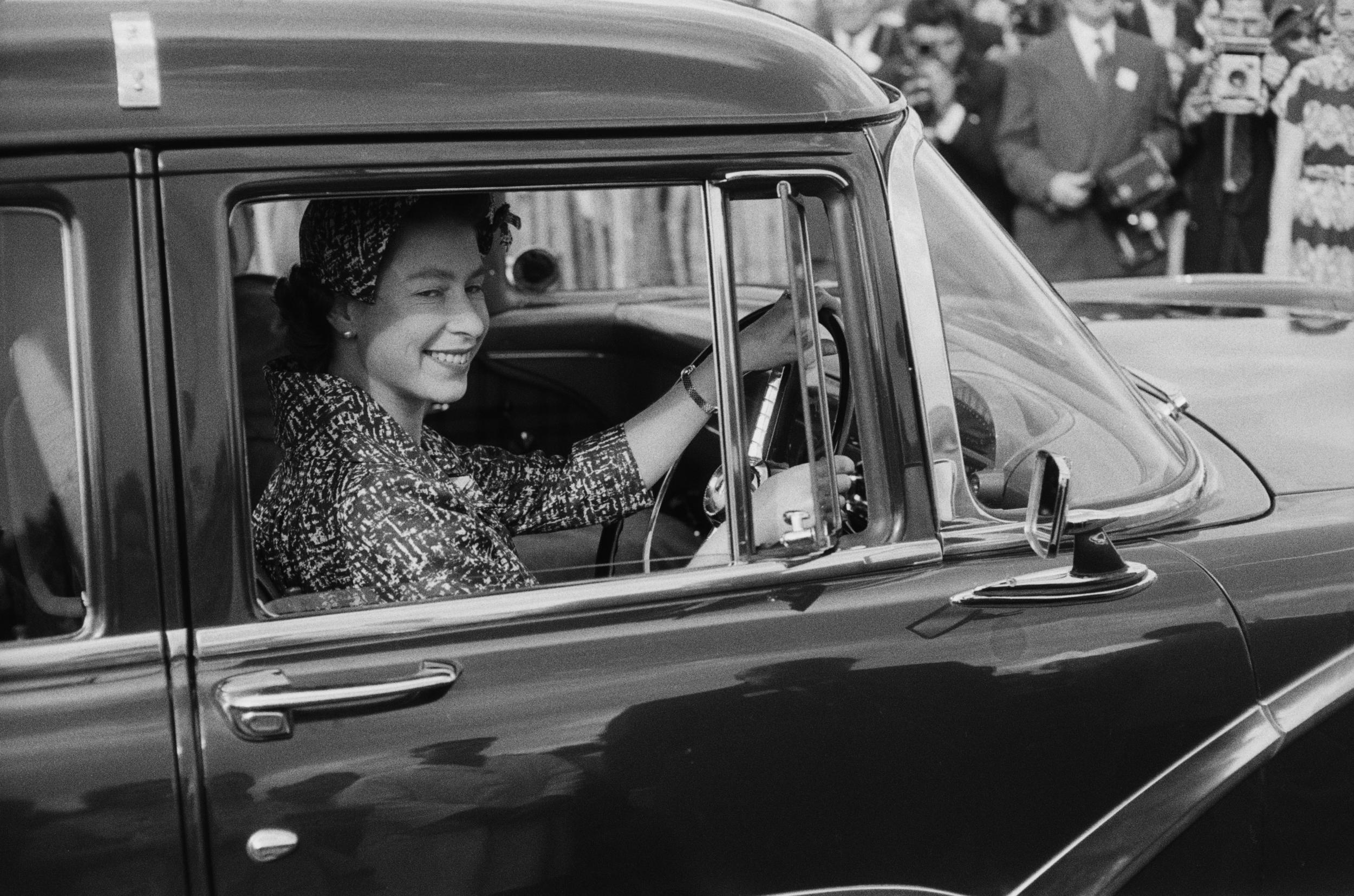 The Queen pictured driving to a polo match in Windsor in 1958.