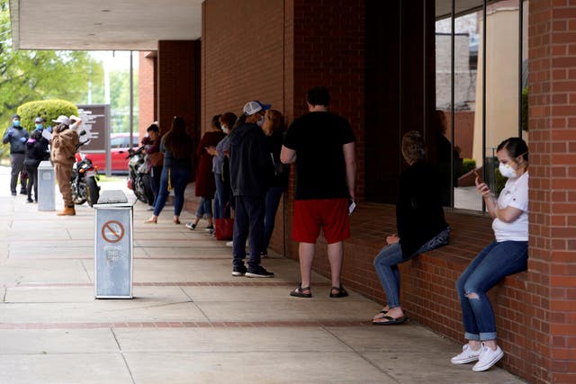 People who lost their jobs wait in line to file for unemployment at an Arkansas Workforce Center in Fort Smith, Arkansas, as the the coronavirus pandemic sweeps across the US.