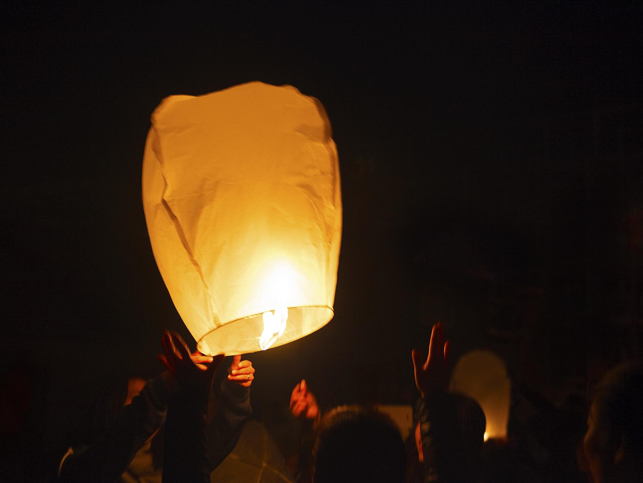 Thousands of lit lanterns fill the sky above Auto City Speedway - mlive.com