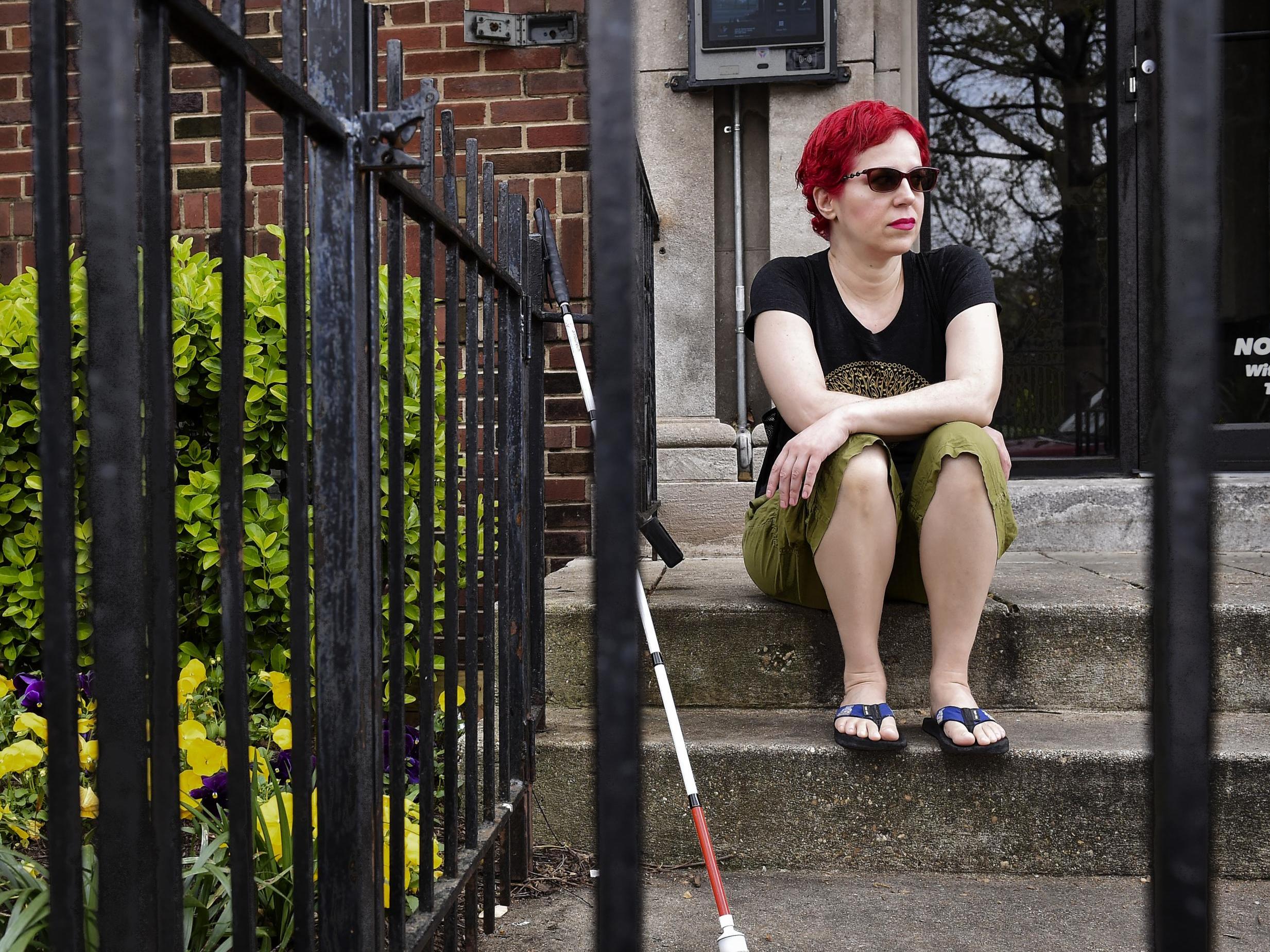 Reis sits on her stoop while waiting for a friend in Washington (The Washington Post)
