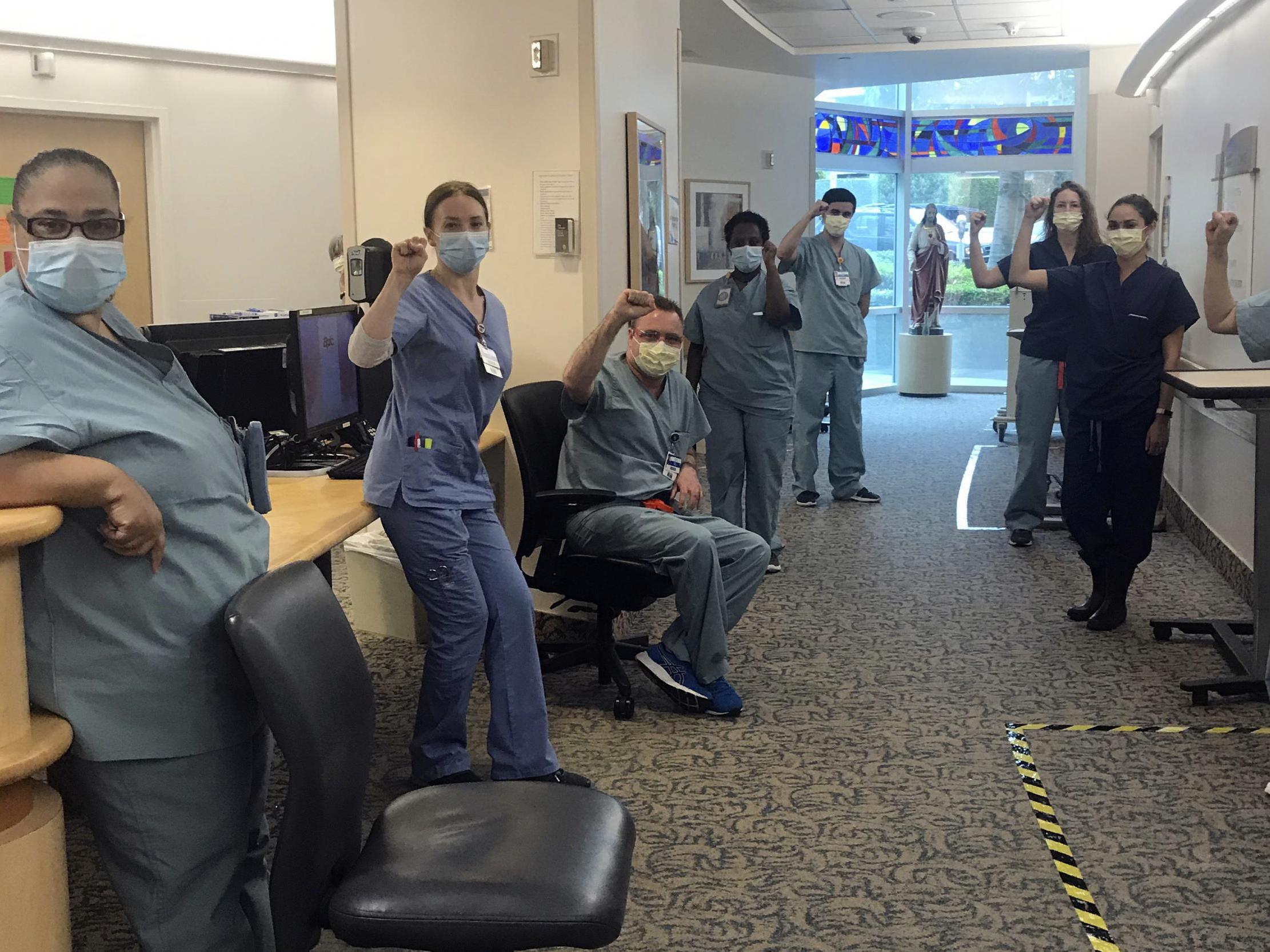 Nurses raise their fists in solidarity after telling managers they can't care for Covid-19 patients without N95 respirator masks