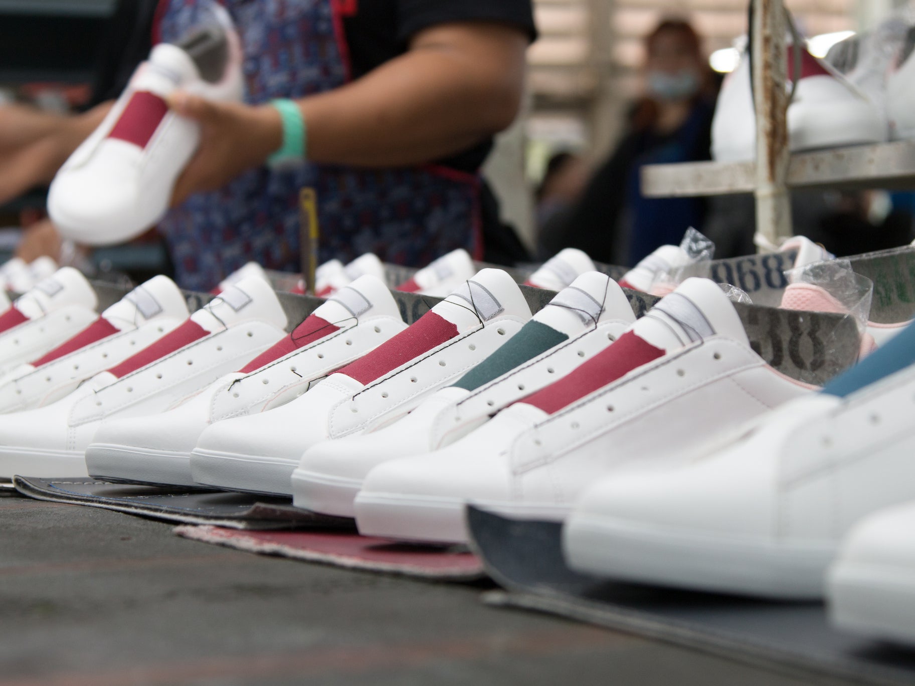 Shoes being mass produced in a factory in Thailand