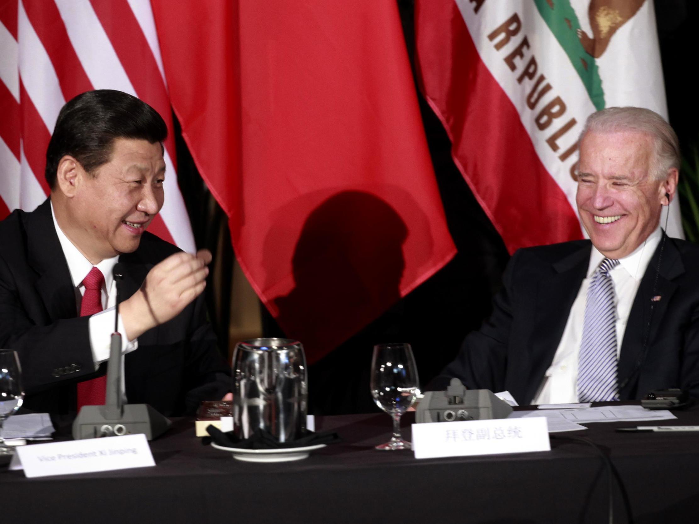Then Chinese Vice President Xi Jinping shares a joke with then US Vice President Joe Biden at Disney Hall Los Angeles in 2012 (Getty Images)
