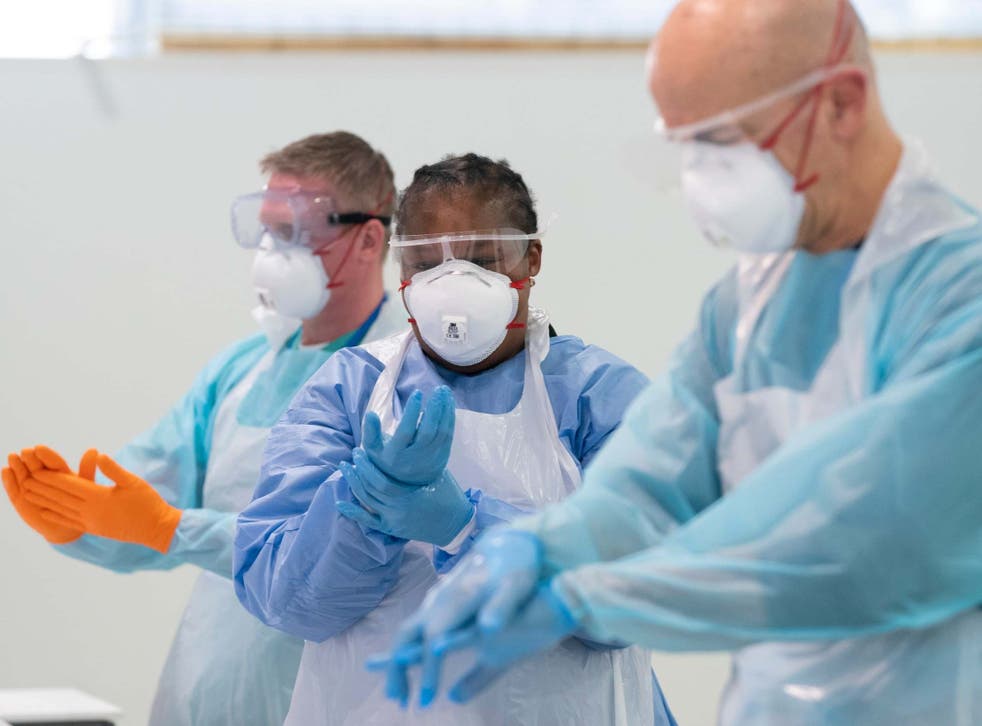 NHS staff receive training on how to put on and remove PPE in Manchester’s Nightingale Hospital