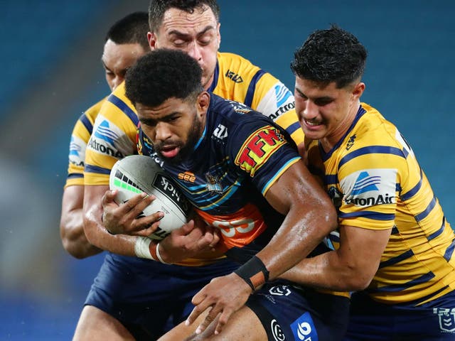 Kallum Watkins (centre) is left Gold Coast Titans after his father contracted coronavirus
