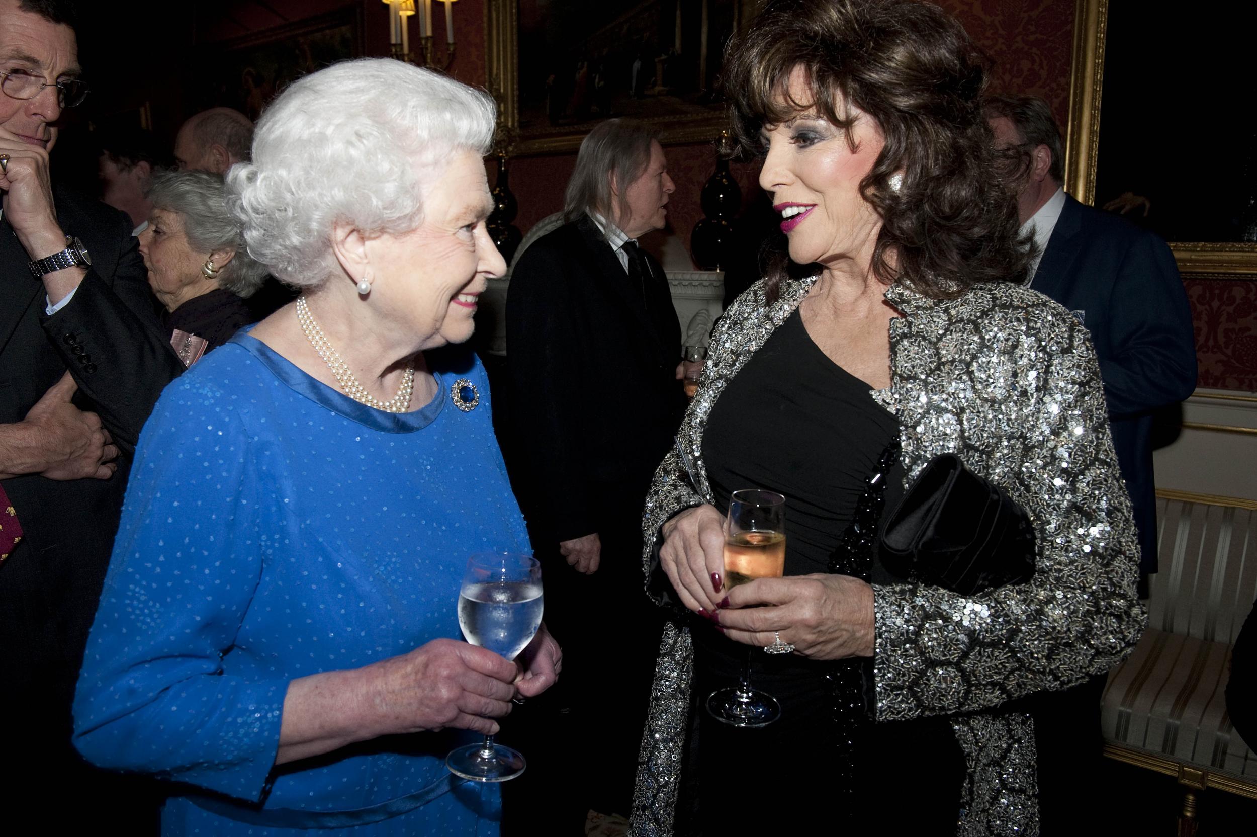 The Queen chats with <i>Dynasty</i> star Dame Joan Collins during the Dramatic Arts reception at Buckingham Palace, 17 February 2013