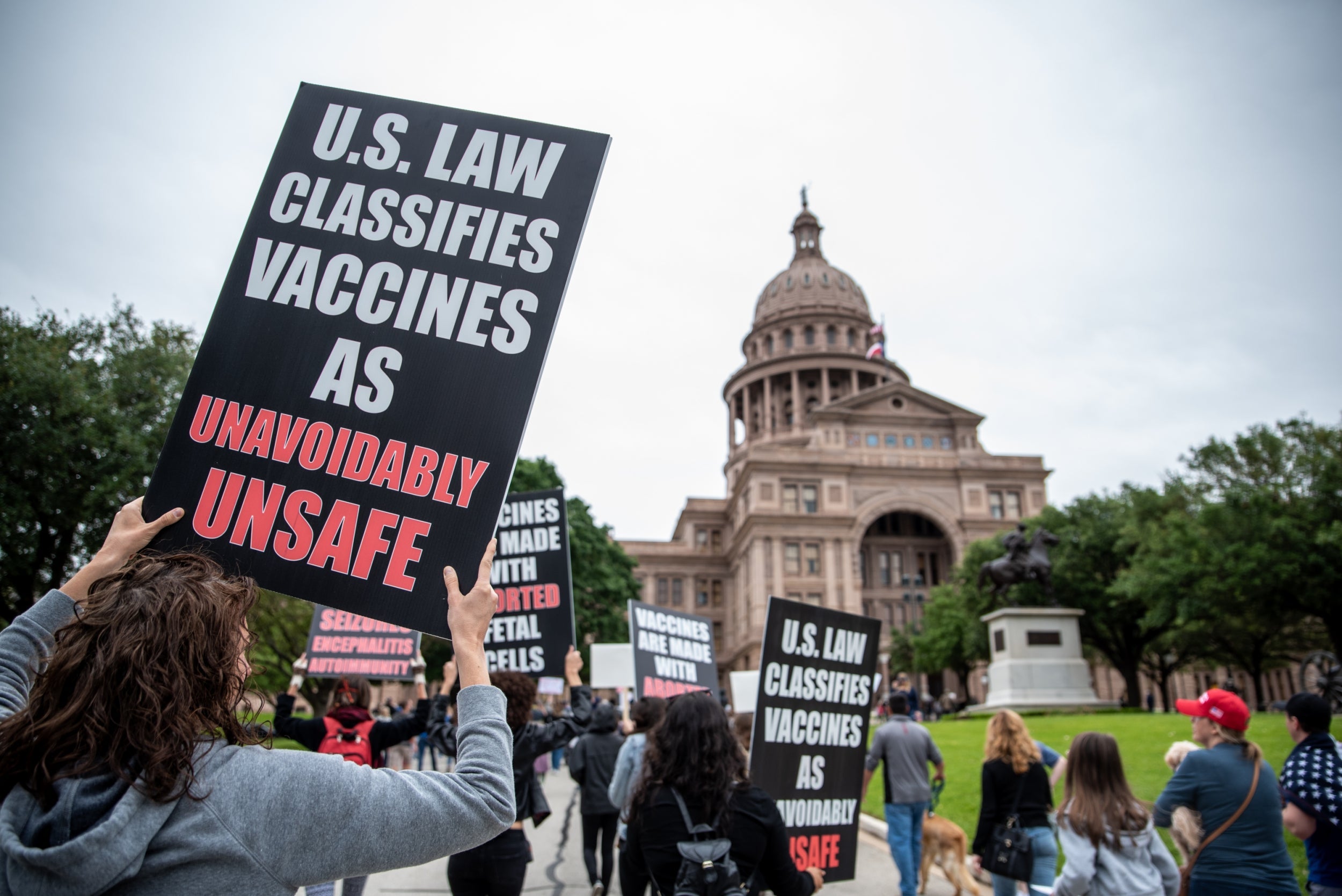 Protesters walk towards the Texas State Capital building on April 18, 2020 in Austin, Texas. The protest was organized by Infowars host Owen Shroyer who is joining other protesters across the country in taking to the streets to call for the country to be opened up despite the risk of Covid-19.