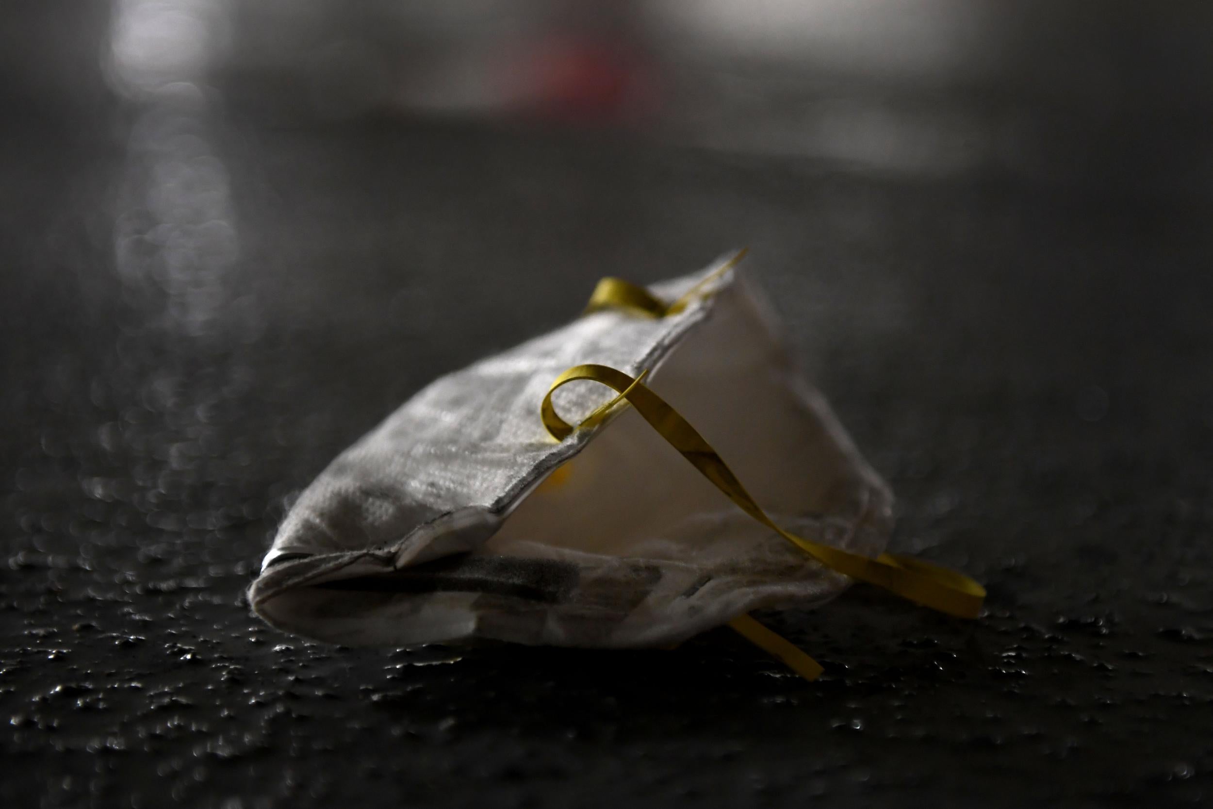 A discarded face mask is strewn on the ground in a parking garage in Washington in April 2020