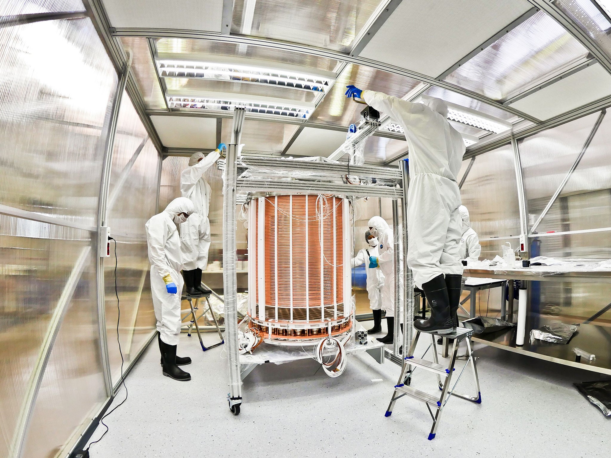 Scientists assemble machinery in a lab that has been built under a mountain