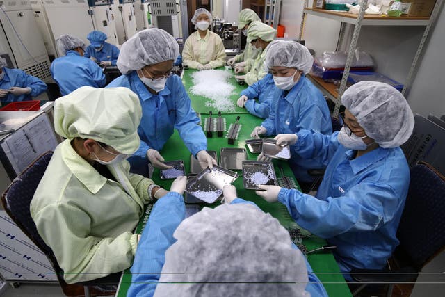 Employees work on the production line of the Ichroma Covid-19 Ab testing kit used in diagnosing the coronavirus at the Boditech Med Inc. headquarters in Chuncheon, South Korea