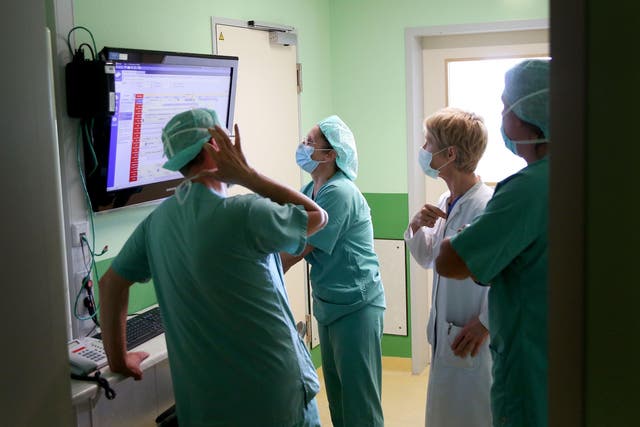 Medical physicians attend the daily surgery scheduling of the community hospital in Magdeburg, eastern Germany, on April 16, 2020 during the novel coronavirus COVID-19 pandemic.