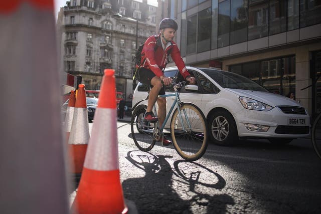 A cyclist negotiates the streets of London