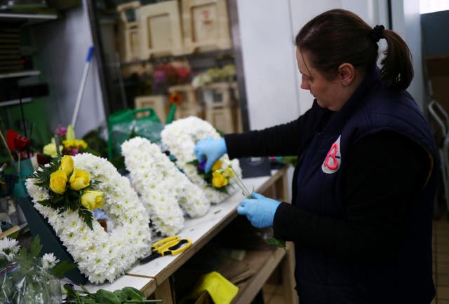 A florist in London makes a funeral tribute