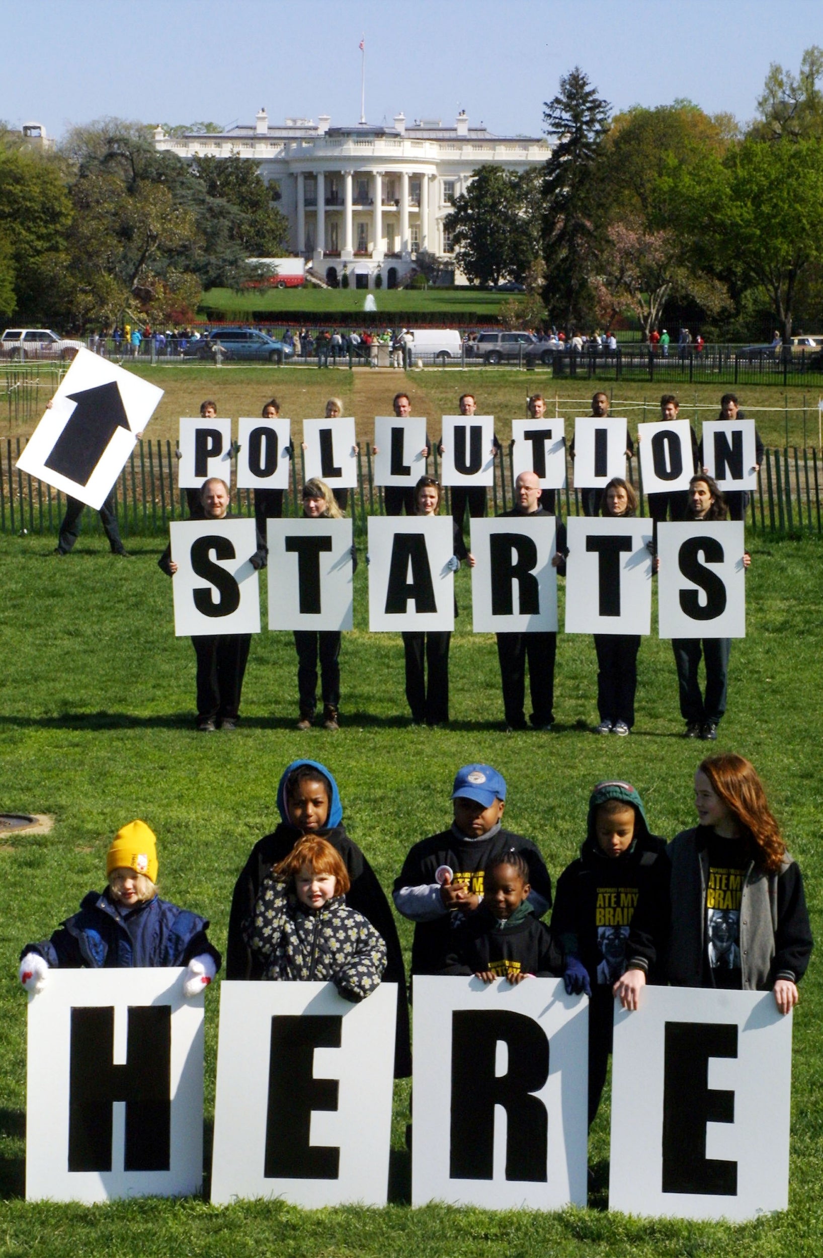 Members of Greenpeace hold banners during the "Take Back the Earth Day" rally to protest President Bush's environmental policies and protocols outside the White House in 2001 (Photo by Alex Wong/Newsmakers)