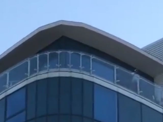 Footage taken near the Dockside Shopping Outlet of a man on a balcony