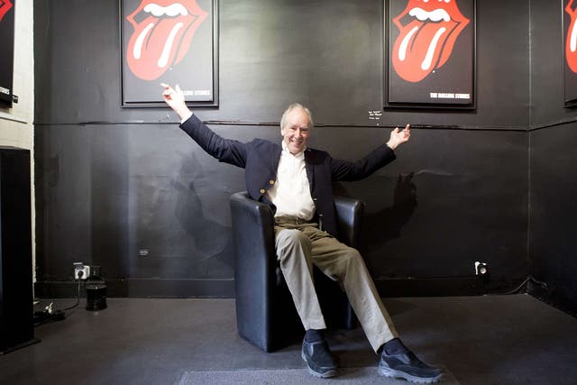 Designer John Pasche poses with his famous logo in Paris