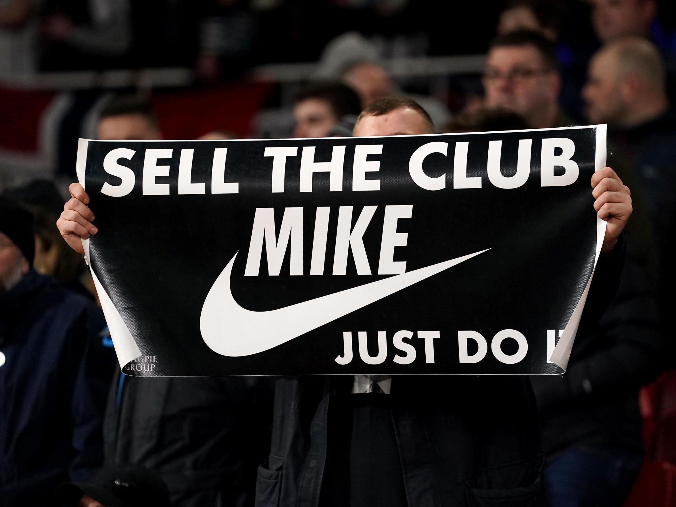A banner is held up by a fan