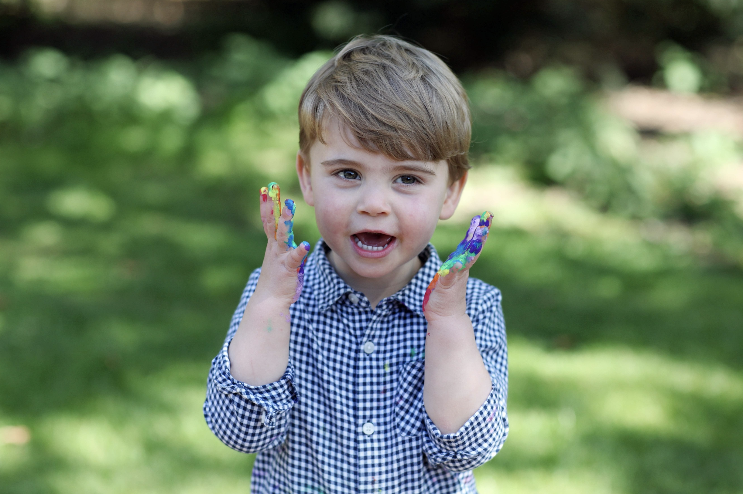 Louis was photographed by his mother, Kate, while painting a rainbow tribute poster (AP)