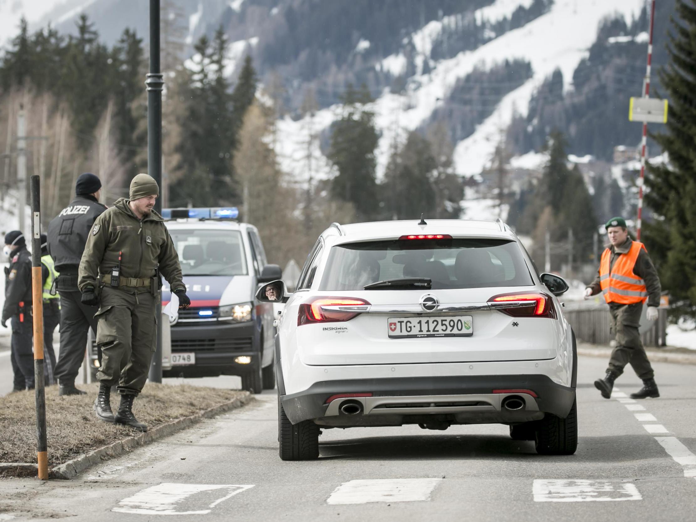 Police at a roadblock stop cars from driving into and out of St Anton following the imposition of a quarantine