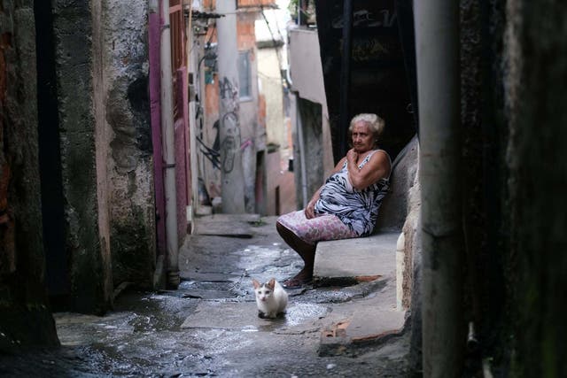 Maria das Neves, 76, cuts a lonely figure in Rio’s Alemao favela