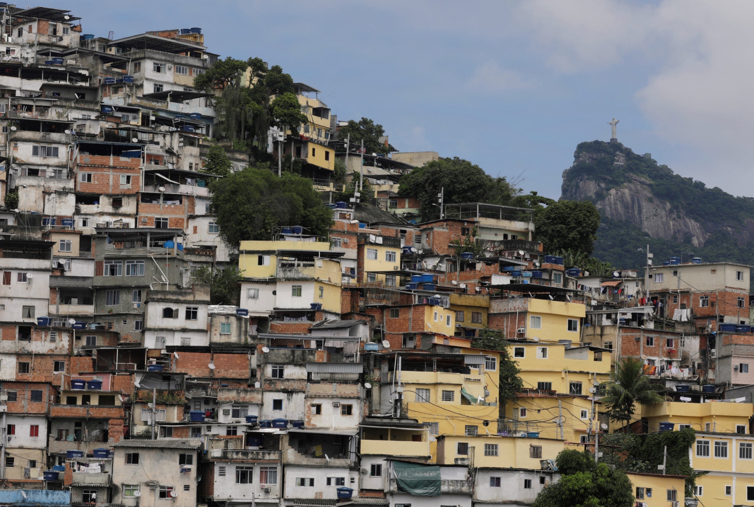 A general view of Coroa favela with the Christ the Redeemer statue in the background