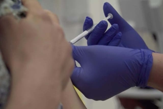 Screen grab taken from video issued by Britain's Oxford University, showing a person being injected as part of the first human trials in the UK to test a potential coronavirus vaccine