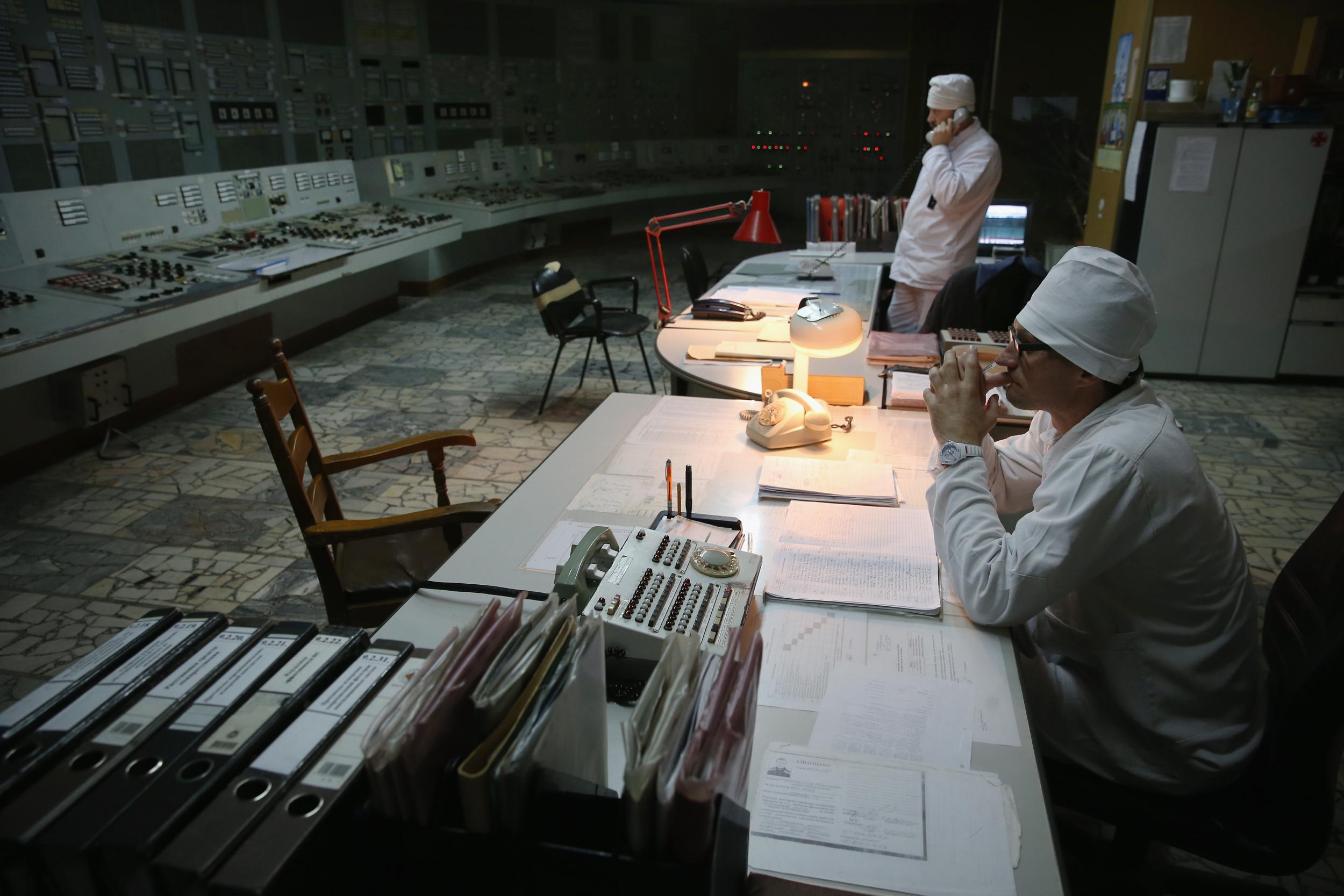 Workers sit in the control room of reactor number two inside the former Chernobyl nuclear power plant in 2015