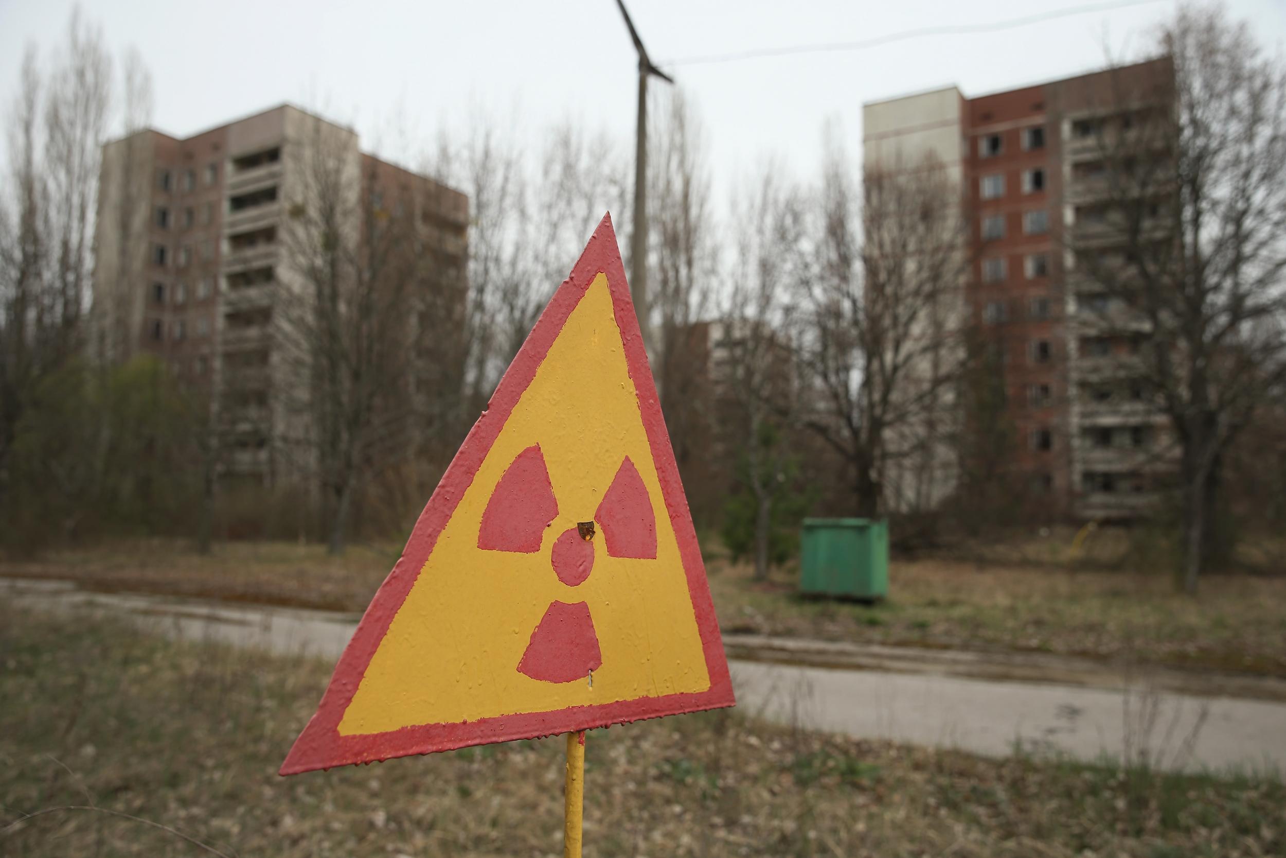 A sign warns of radiation contamination near former apartment buildings in Pripyat in 2016