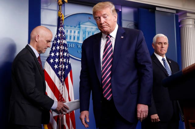 Donald Trump at a White House briefing on the coronavirus pandemic with Stephen Hahn, left, commissioner of the US Food and Drug Administration, and Vice-President Mike Pence