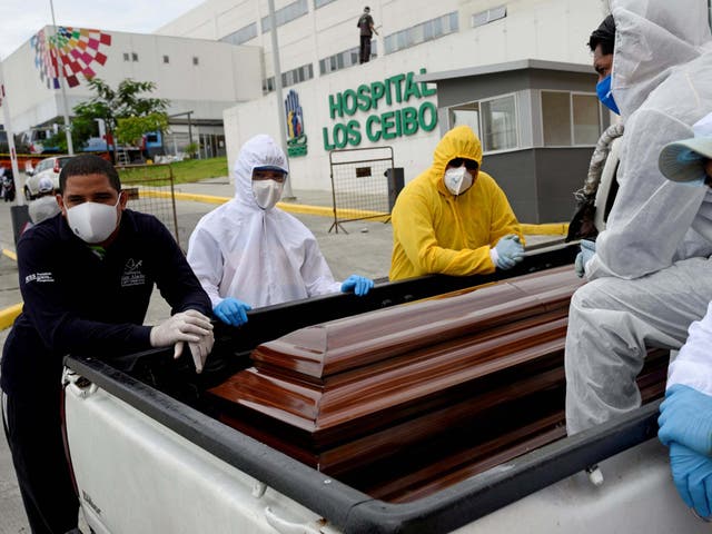 Funeral workers use a pick-up truck in Guayaquil, Equador, as the country struggles