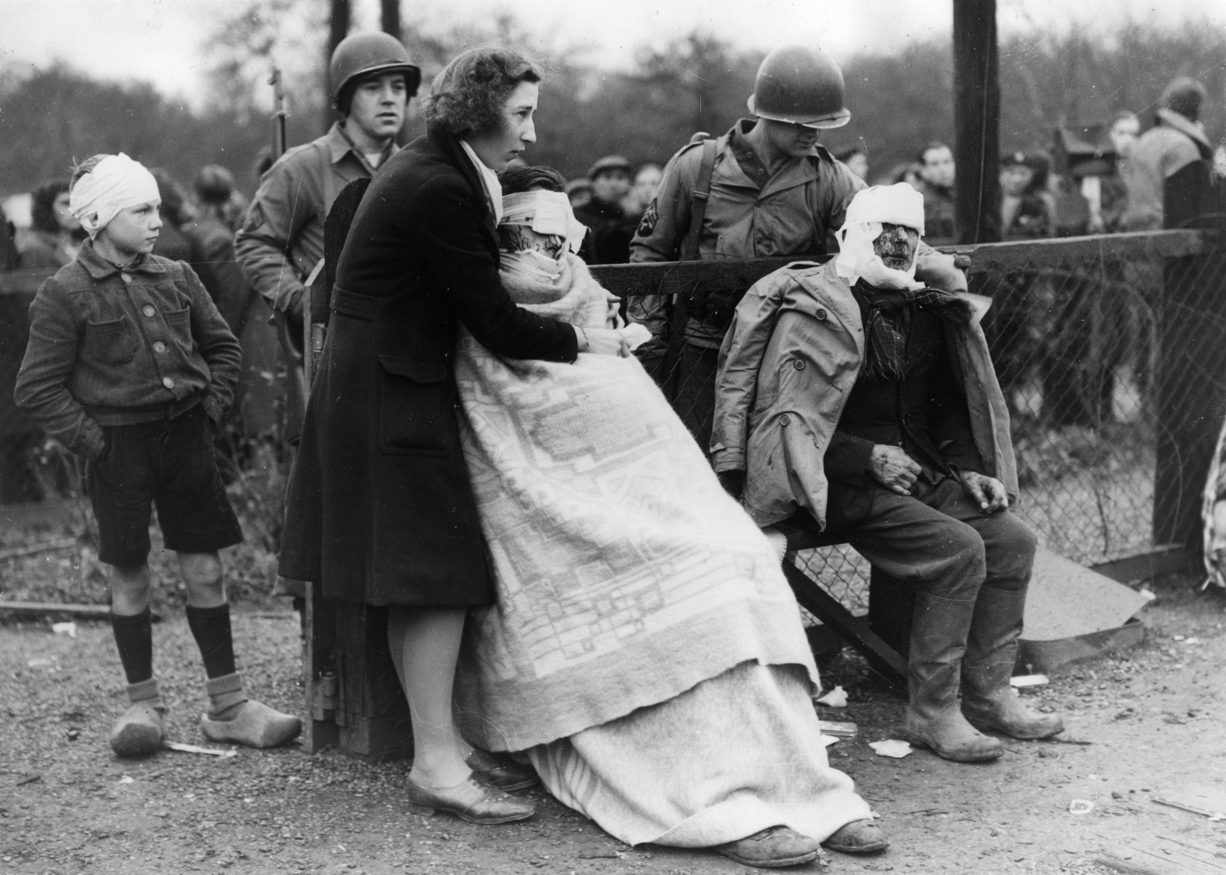 American soldiers tend to injuries caused when a flying bomb landed on the outskirts of a Dutch town