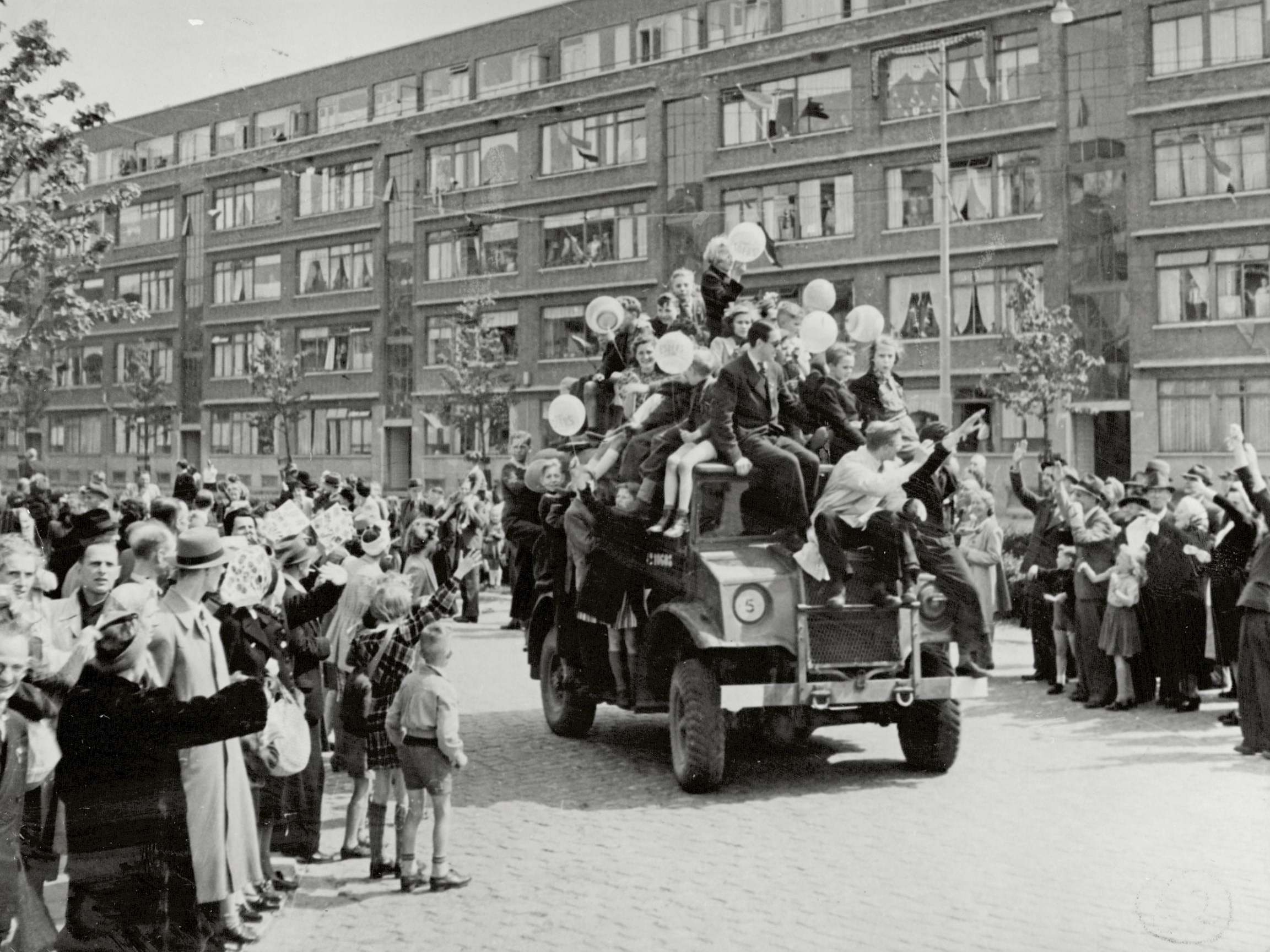 Victory scene in The Hague as Lancaster bombers pass overhead on their way to a food drop