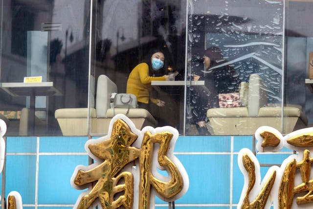 People eat at a restaurant in Guangzhou, China on 23 April. A study conducted at a different restaurant in January found that the coronavirus was spread by an air-conditioning unit