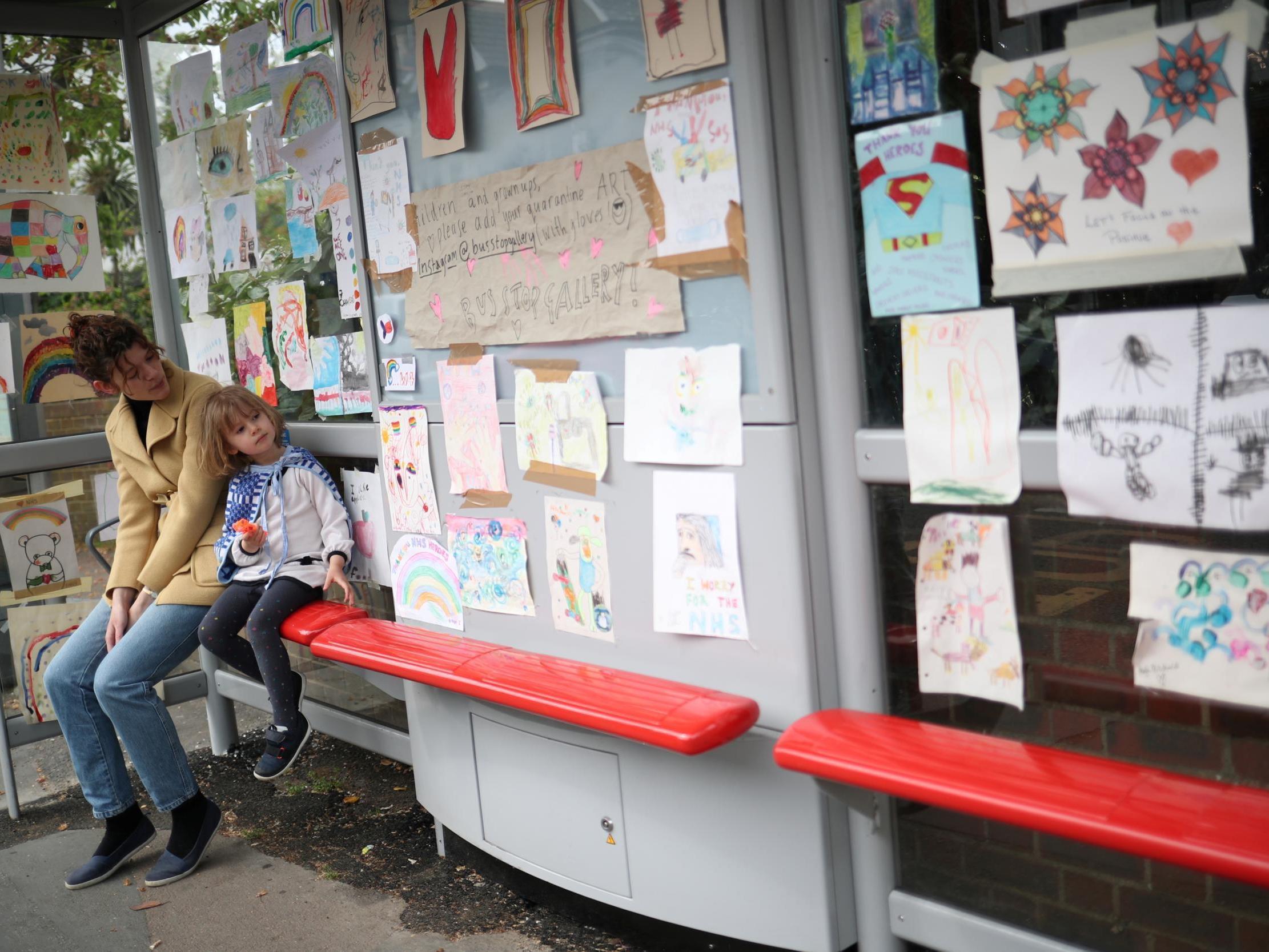 Sarah Lamarr and her four-year-old daughter Rosie at the bus stop gallery (Reuters)