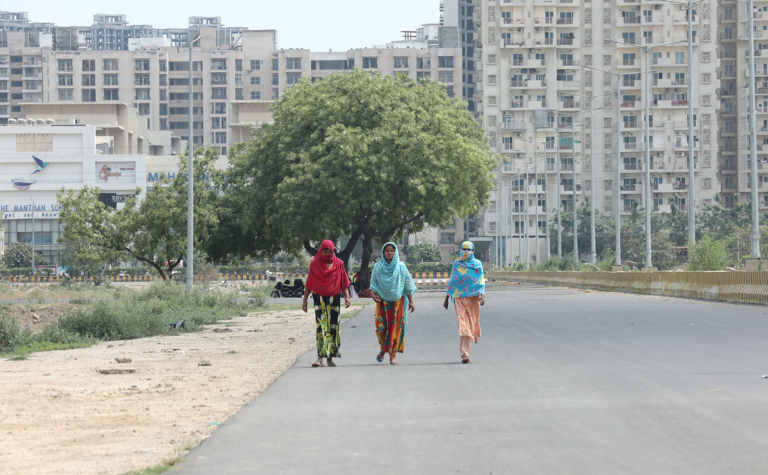 Women walk in the Noida area near New Delhi